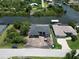Stunning aerial view of waterfront property with lush landscaping and canal access for boating at 10048 Winnipeg St, Port Charlotte, FL 33981