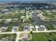 Aerial shot of a canal-front home under construction with seawall and a potential dock at 10048 Winnipeg St, Port Charlotte, FL 33981