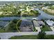 A waterfront property featuring a modern home under construction with a black roof and canal access at 10048 Winnipeg St, Port Charlotte, FL 33981