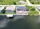 Aerial view of a waterfront lot featuring a home under construction, dock and canal access at 10048 Winnipeg St, Port Charlotte, FL 33981