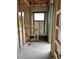 Future bathroom view, framed and ready for finishing with a window view to the backyard nature and lake at 10048 Winnipeg St, Port Charlotte, FL 33981
