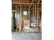 Framing of a room, with visible wall studs, window openings and plumbing lines for future buildout at 10048 Winnipeg St, Port Charlotte, FL 33981