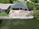 New home construction with retaining wall overlooking water and a fenced in pool construction at 10048 Winnipeg St, Port Charlotte, FL 33981