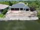 New home construction with retaining wall overlooking water and a fenced in pool construction at 10048 Winnipeg St, Port Charlotte, FL 33981