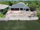New home construction with retaining wall overlooking water and a fenced in pool construction at 10048 Winnipeg St, Port Charlotte, FL 33981
