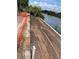 Cleared waterfront lot, ready for construction, with a canal view and construction fence at 10048 Winnipeg St, Port Charlotte, FL 33981