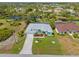 Aerial view of a home with a private pool, beautiful landscaping, and waterfront views at 116 Tournament Rd, Rotonda West, FL 33947