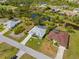 Aerial view of a residential neighborhood with a mix of homes, ponds and mature trees at 116 Tournament Rd, Rotonda West, FL 33947