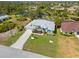 Aerial view of a home with a private pool, lush landscaping, and a spacious backyard at 116 Tournament Rd, Rotonda West, FL 33947