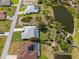 Aerial view of a well-maintained single-Gathering home with a pool and landscaped yard near a scenic pond at 116 Tournament Rd, Rotonda West, FL 33947
