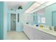Elegant bathroom featuring a large vanity with dual sinks and a separate shower area at 116 Tournament Rd, Rotonda West, FL 33947