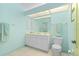 Bright bathroom featuring a double vanity, a toilet, and a large mirror at 116 Tournament Rd, Rotonda West, FL 33947