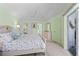 Spacious bedroom with a ceiling fan, closet, and an attached bathroom and light green walls at 116 Tournament Rd, Rotonda West, FL 33947
