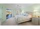 Inviting bedroom with soft green walls and a sliding door leading to the outdoor pool area at 116 Tournament Rd, Rotonda West, FL 33947