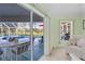 Bedroom with direct access to an enclosed patio featuring a swimming pool and seating area at 116 Tournament Rd, Rotonda West, FL 33947