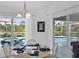Dining area features a table with white chairs and a view of the pool and outdoor seating at 116 Tournament Rd, Rotonda West, FL 33947