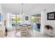Bright dining area with white tile floors, a round table, and a view of the pool and patio at 116 Tournament Rd, Rotonda West, FL 33947