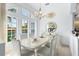 Elegant dining room with natural lighting, a decorative chandelier, and stylish furnishings at 116 Tournament Rd, Rotonda West, FL 33947
