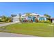Beautiful home with blue accents, well-manicured lawn, and inviting curb appeal at 116 Tournament Rd, Rotonda West, FL 33947
