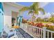 Inviting front porch with comfortable seating and colorful landscaping enhances curb appeal at 116 Tournament Rd, Rotonda West, FL 33947