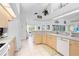Spacious kitchen with white appliances, light-colored cabinets, and a tile backsplash at 116 Tournament Rd, Rotonda West, FL 33947
