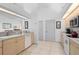 Functional kitchen featuring light wood cabinetry, white appliances, and tile flooring at 116 Tournament Rd, Rotonda West, FL 33947