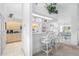 Open kitchen with light wood cabinetry, white countertops, and a breakfast bar at 116 Tournament Rd, Rotonda West, FL 33947