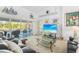 Cozy living room with comfortable leather seating, a glass coffee table, and a view of the pool at 116 Tournament Rd, Rotonda West, FL 33947