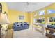 Bright office with yellow walls, a comfortable sofa, and natural light from multiple windows at 116 Tournament Rd, Rotonda West, FL 33947