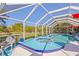 Enclosed pool and spa with a covered screen offers private relaxation at 116 Tournament Rd, Rotonda West, FL 33947