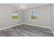 This light-filled bedroom features wood-look flooring, neutral walls, recessed lights and dual windows offering natural views at 12 Current Ln, Placida, FL 33946