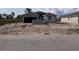 Unfinished home exterior, showcasing the initial construction phase, with the landscape yet to be finalized in the front yard at 12 Current Ln, Placida, FL 33946