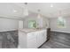 Bright, open kitchen boasts granite countertops, stainless appliances, and contemporary pendant lighting at 12 Current Ln, Placida, FL 33946