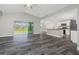 Open living area flows into a modern kitchen with stainless appliances and granite countertops at 12 Current Ln, Placida, FL 33946