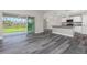 Open-concept living space with seamless flow to outdoor patio through sliding glass doors and kitchen with bar and granite countertops at 12 Current Ln, Placida, FL 33946