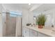 Bright bathroom with white vanity, contemporary fixtures, and a tiled shower area at 12470 Wellen Golf St # 108, Venice, FL 34293