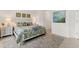 Inviting bedroom with a comfortable bed, stylish decor, and a tranquil ambiance with ample space at 12470 Wellen Golf St # 108, Venice, FL 34293