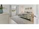 Serene bedroom featuring a comfortable bed, stylish decor, and a peaceful atmosphere with outdoor views at 12470 Wellen Golf St # 108, Venice, FL 34293