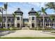 Elegant commercial building featuring twin towers, palm trees, and pedestrian-friendly walkways, enhancing its appeal at 12470 Wellen Golf St # 108, Venice, FL 34293