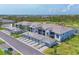 New condos featuring attached garages, lush landscaping, golf course view, and a modern neutral color scheme at 12470 Wellen Golf St # 108, Venice, FL 34293