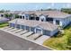 New condos featuring attached garages, manicured lawns, and modern neutral color scheme at 12470 Wellen Golf St # 108, Venice, FL 34293