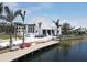Scenic waterfront view with a modern building, inviting dock area, and comfortable seating, creating a serene ambiance at 12470 Wellen Golf St # 108, Venice, FL 34293