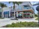 Charming Foxtail Coffee Co. storefront with large windows, outdoor seating, and lush landscaping at 12470 Wellen Golf St # 108, Venice, FL 34293
