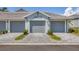 Attached garages with a modern driveway and beautifully maintained front lawn at 12470 Wellen Golf St # 108, Venice, FL 34293