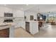 Bright, modern kitchen featuring stainless steel appliances, an island, and an open-concept floor plan at 12470 Wellen Golf St # 108, Venice, FL 34293