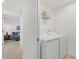 Efficient laundry room with side-by-side washer and dryer, and overhead storage shelf at 12470 Wellen Golf St # 108, Venice, FL 34293