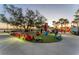 Community gathering space with colorful Adirondack chairs, vibrant turf, and a relaxed atmosphere at 12470 Wellen Golf St # 108, Venice, FL 34293