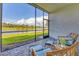 Relaxing screened patio with comfortable seating and scenic golf course views at 12470 Wellen Golf St # 108, Venice, FL 34293
