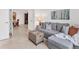 Inviting sitting area featuring a plush gray sofa, decorative accents, and ample natural light at 12470 Wellen Golf St # 108, Venice, FL 34293