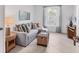Cozy sitting area with a comfortable sofa, decorative pillows, and a view of the outdoors at 12470 Wellen Golf St # 108, Venice, FL 34293